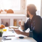 A man at a desk writing a blog about mortgages