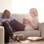 Middle-aged couple relaxing on a sofa